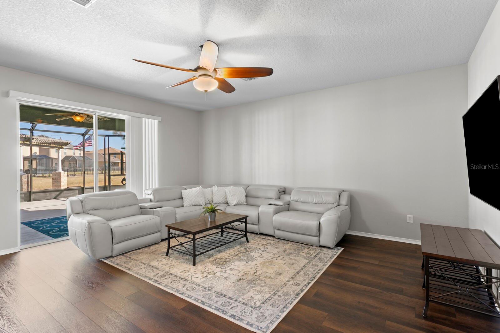 Large family room with sliders out to screened lanai