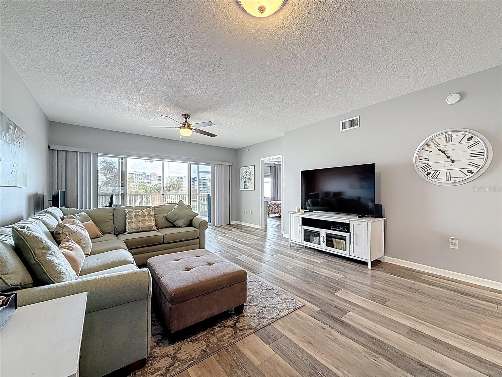 Living Space - Primary Suite - Screened Lanai & Patio Beyond