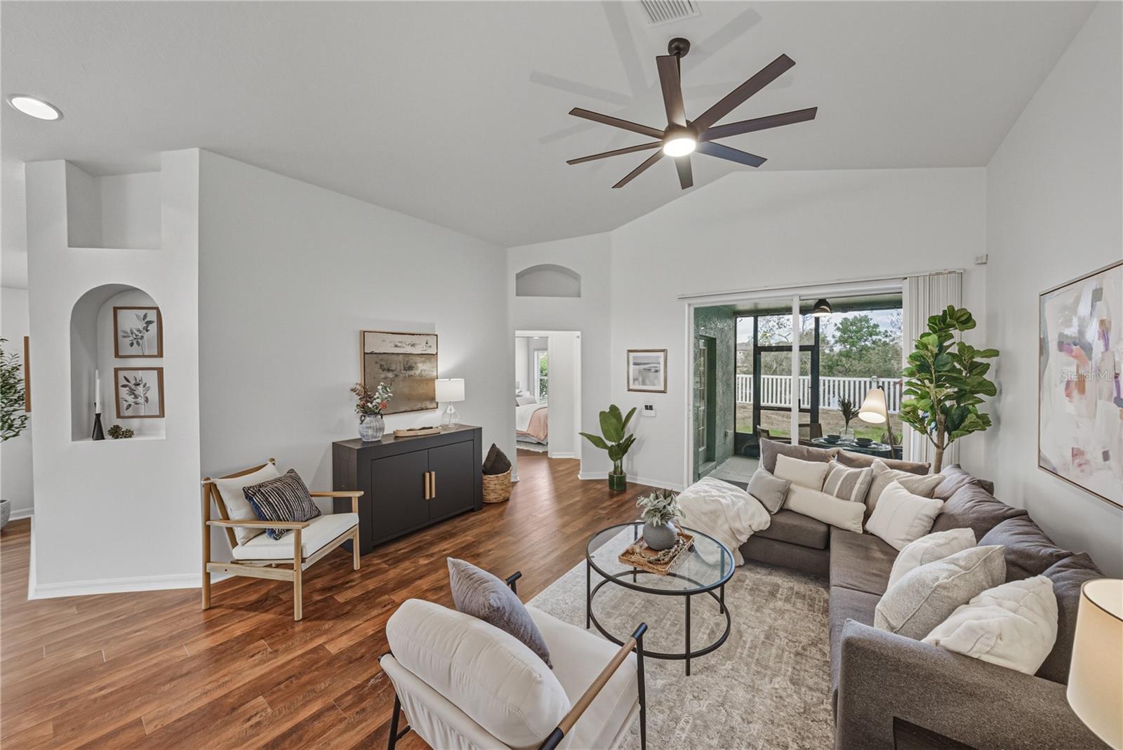 Family Room open to Covered Screened Lanai and Conservation Fenced Yard
