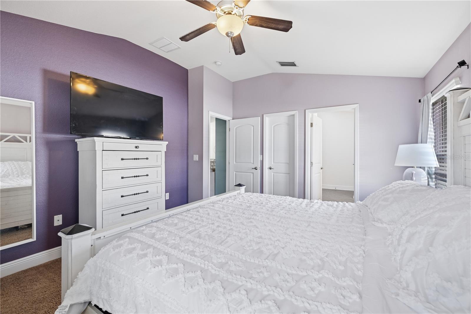 Primary bedroom with walk in closet and en suite bathroom