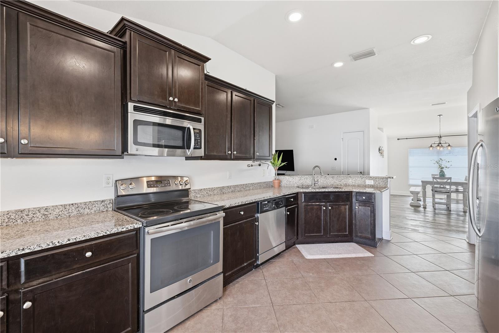 Expansive kitchen with granite counter tops and stainless steel appliances