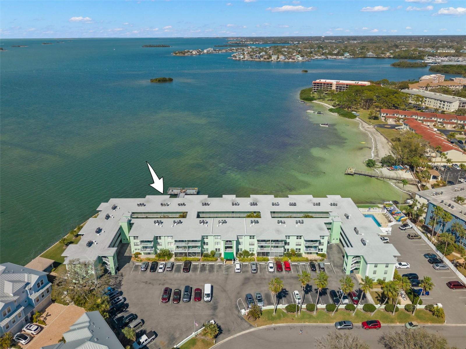 Exceptional waterfront setting nestled along the bay, offering direct water access and panoramic coastal views.