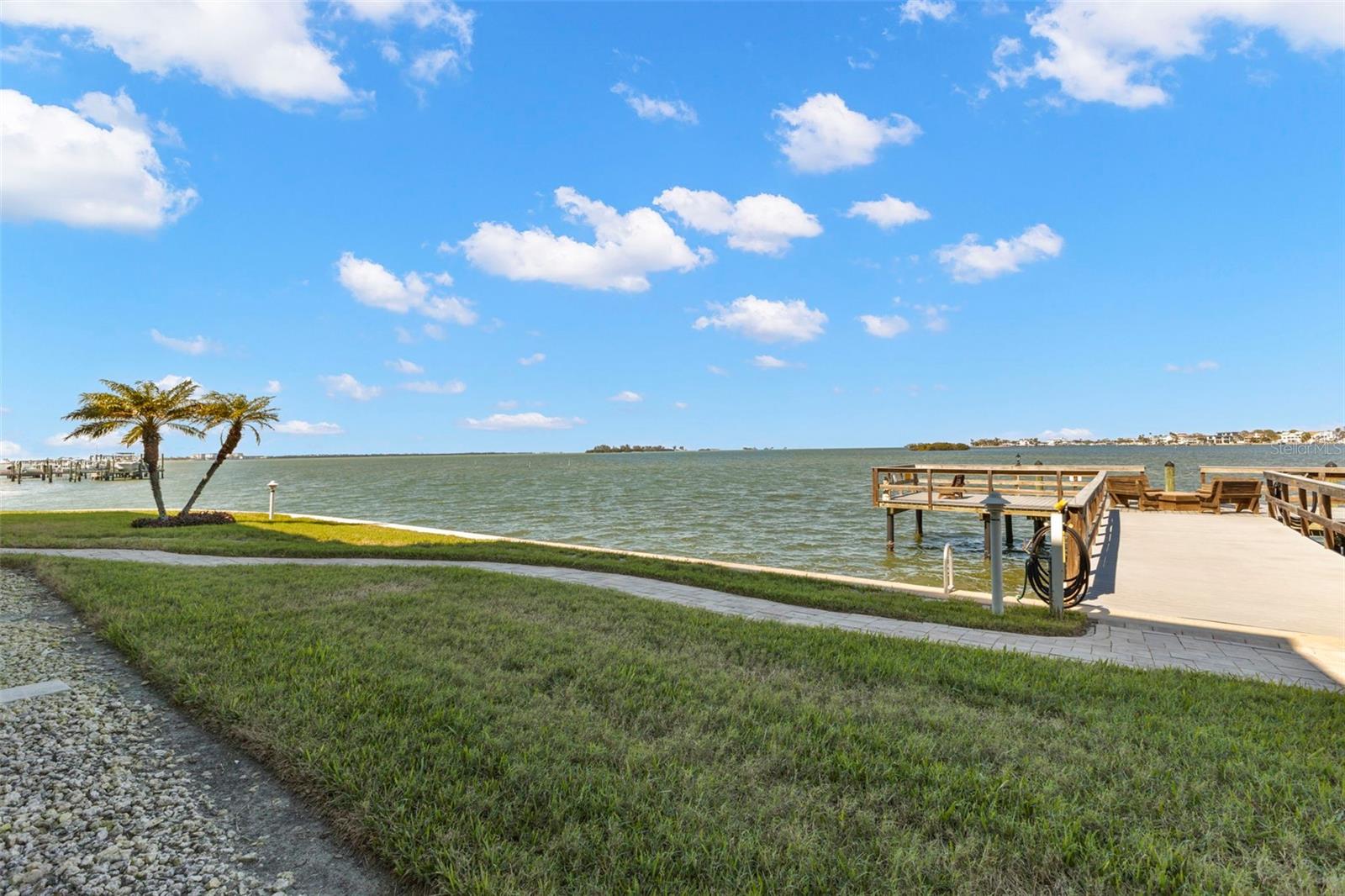 Direct waterfront setting with dock and panoramic water views.