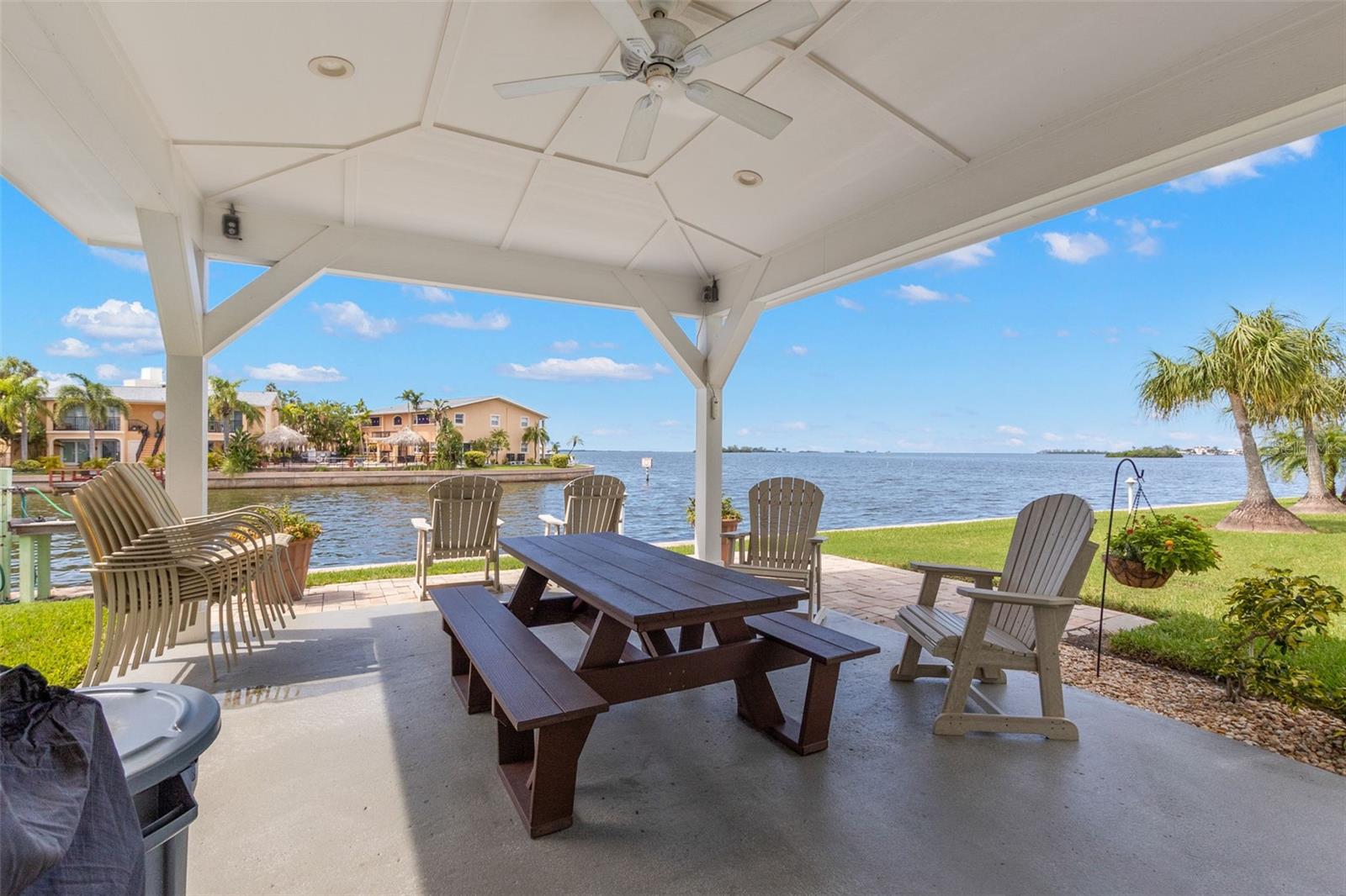 Covered waterfront community pavilion with picnic seating and panoramic bay views.