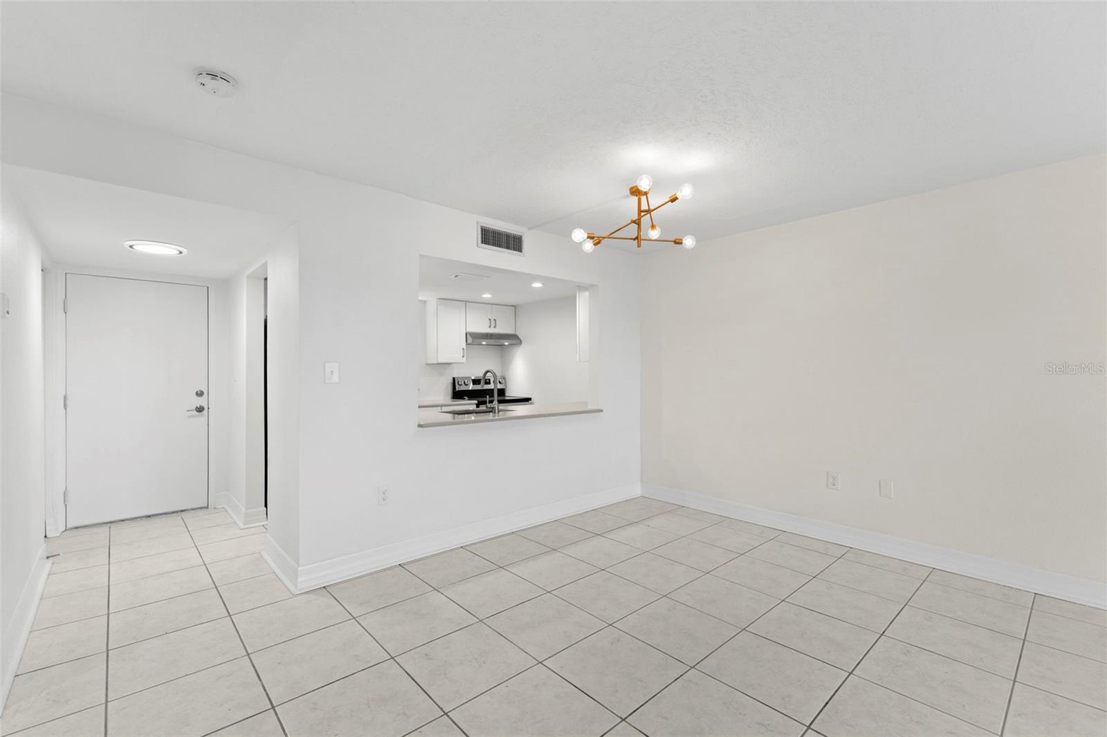 Well-proportioned dining space with neutral finishes, updated lighting, and seamless connectivity to the kitchen for a cohesive living experience.