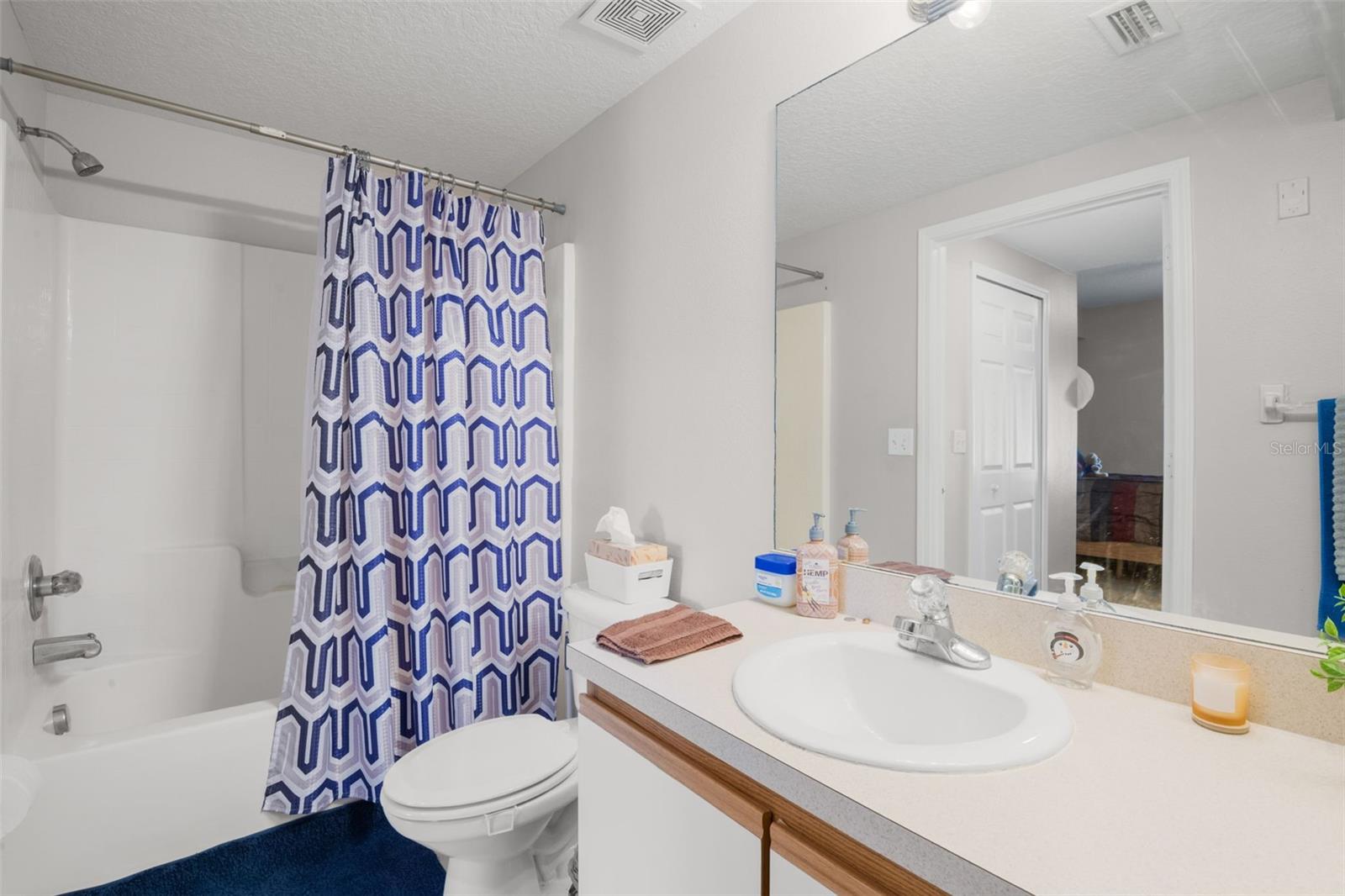 Well-appointed en suite bath offering a single-sink vanity and a tub/shower combination. The light color palette enhances the sense of space, while the practical layout provides comfort and everyday ease within the private primary suite.