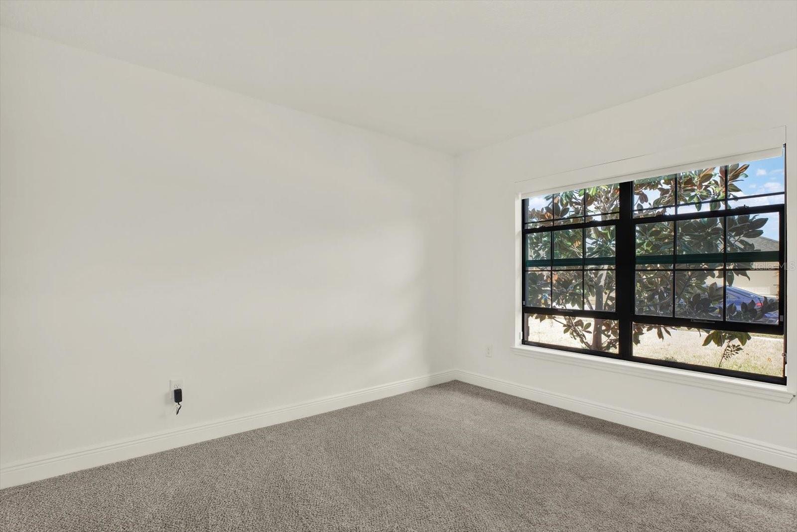 Bedroom with double doors and closet.