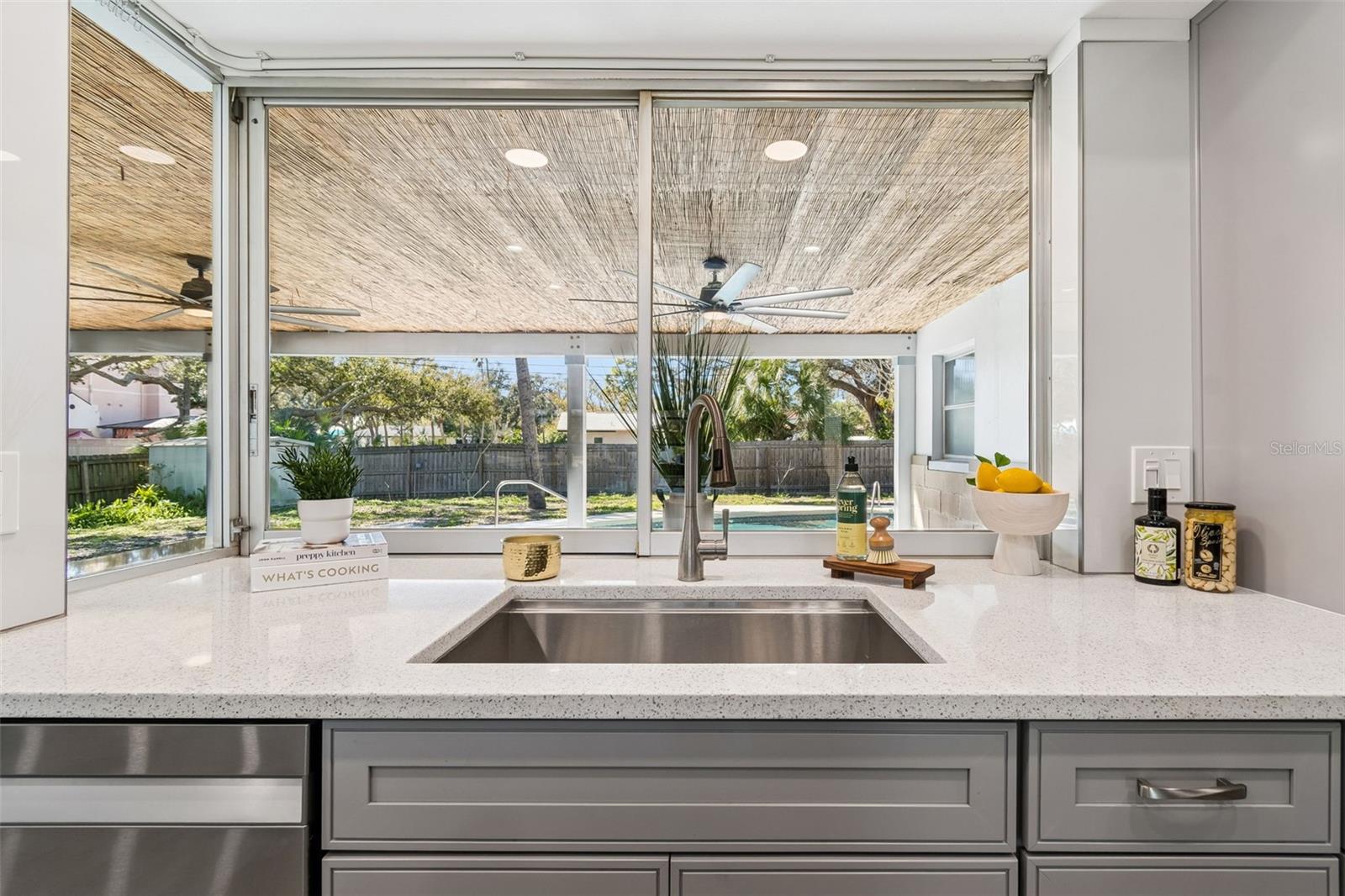View from Kitchen Sink out to patio and pool