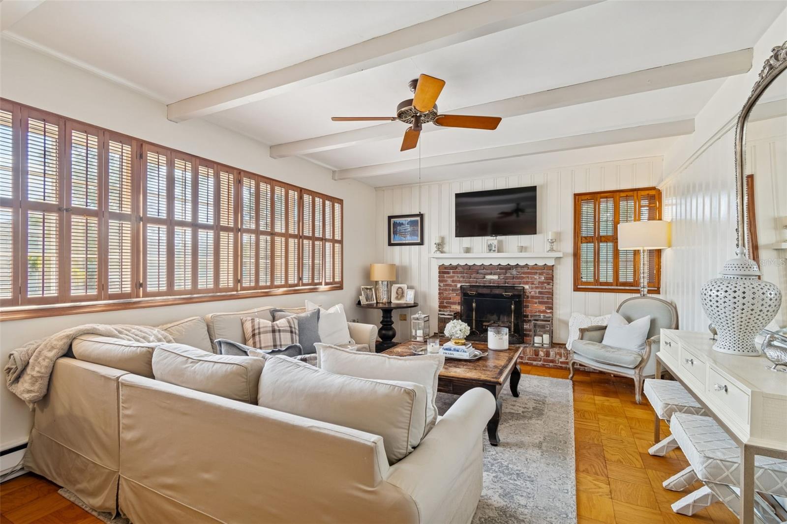 Formal Living Room w/Wood Beams, Wood Shutters, & Brick Fireplace