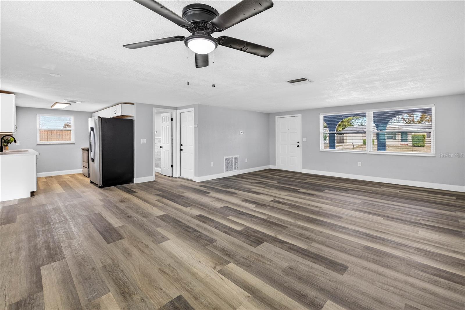 LIVING ROOM/ DINING ROOM / KITCHEN COMBO. LUXURY VINYL FLOORING THROUGH-OUT