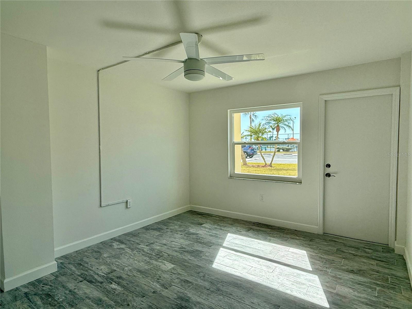 Large 14x11 bedroom with tile flooring.