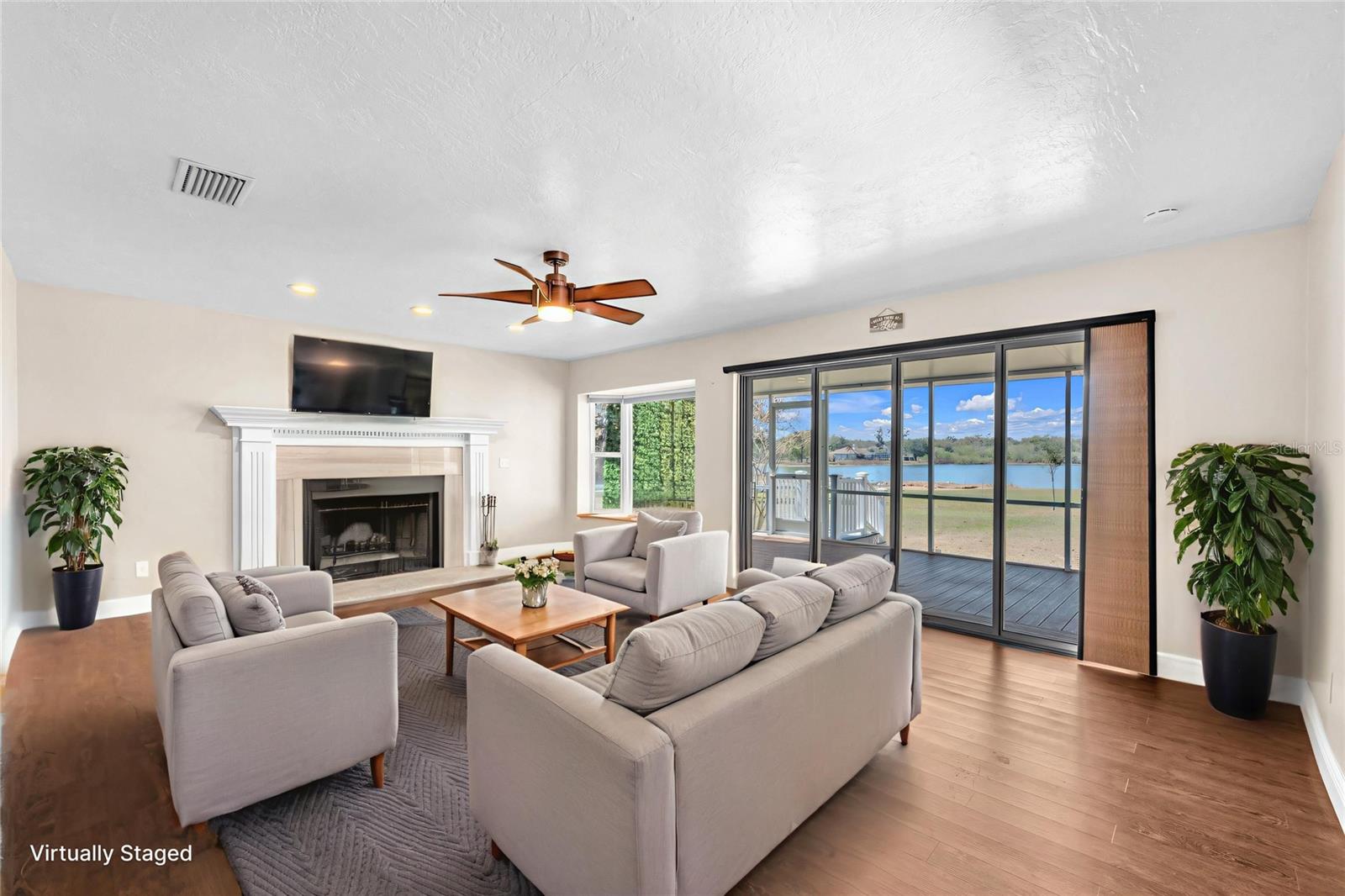 The large Living room is highlighted by a charming bay window, a wall of glass sliding doors and a Pinterest-worthy wood-burning fireplace with custom mantle and hearth.