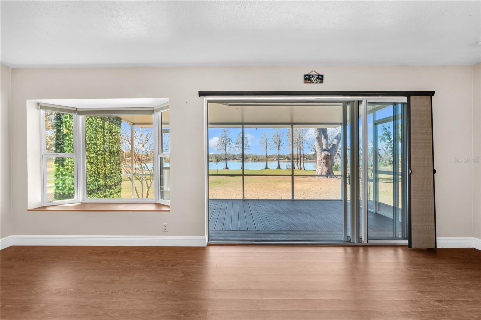 A full wall of accordian glass doors opens wide to a covered, screened lanai and priceless views of Valrico Lake.