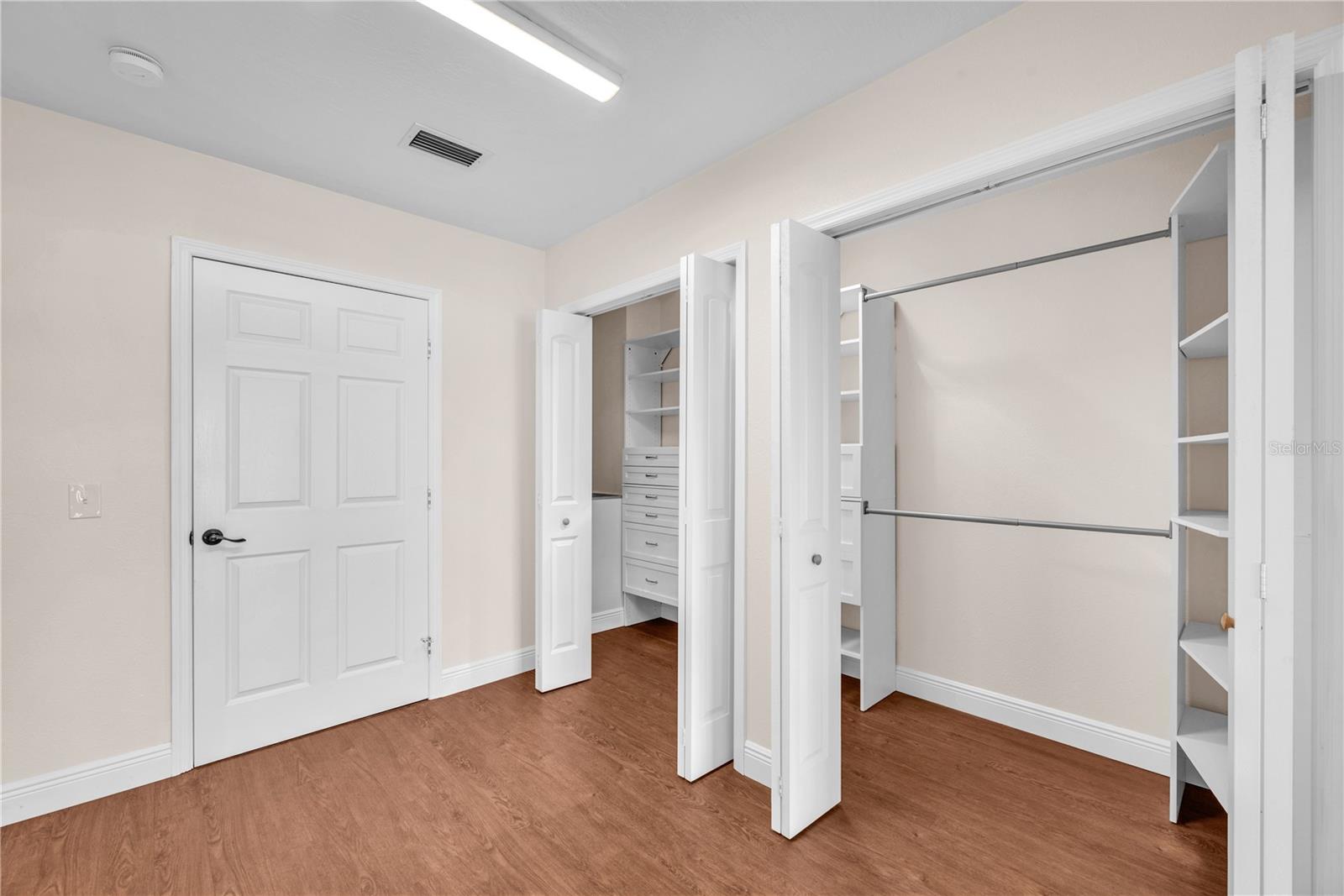 The owner’s suite features a spacious 4' x 14' walk-in closet with custom built-in drawers and shelving, enhanced by a solar tube that fills the space with natural light.