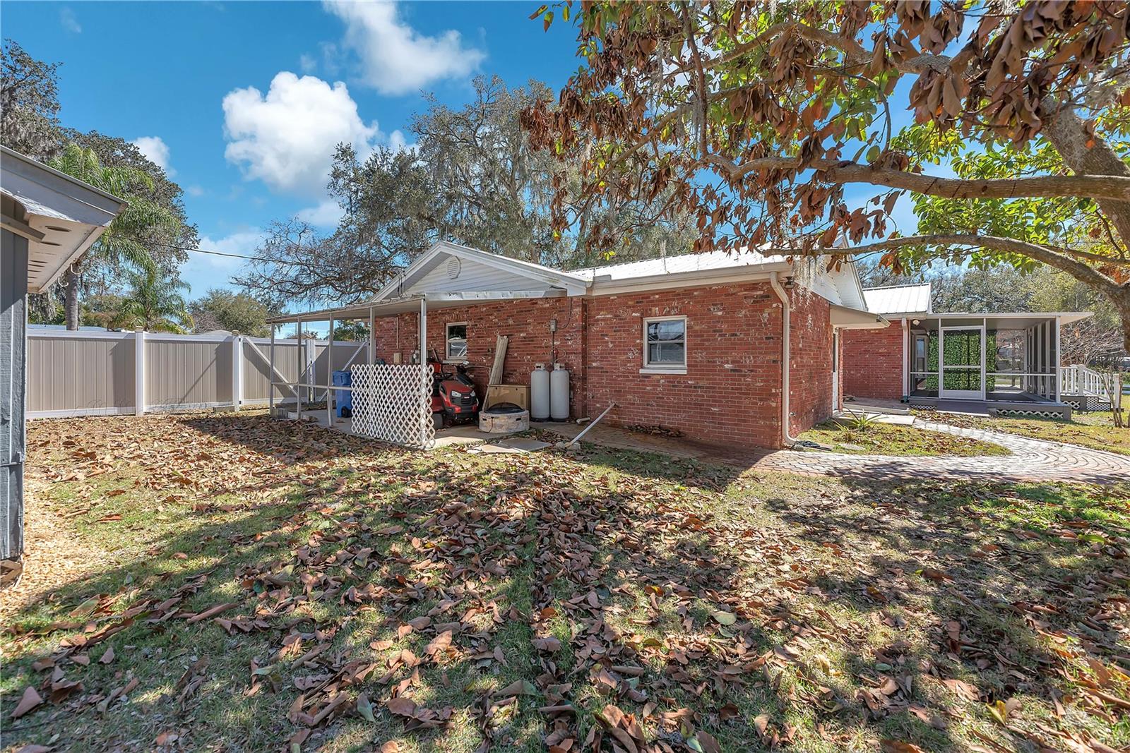 The carport provides space for large equipment and houses a Guardian generator for peace of mind during storms. The generator automatically powers select outlets in the house during outages and is fueled by two owned propane tanks.