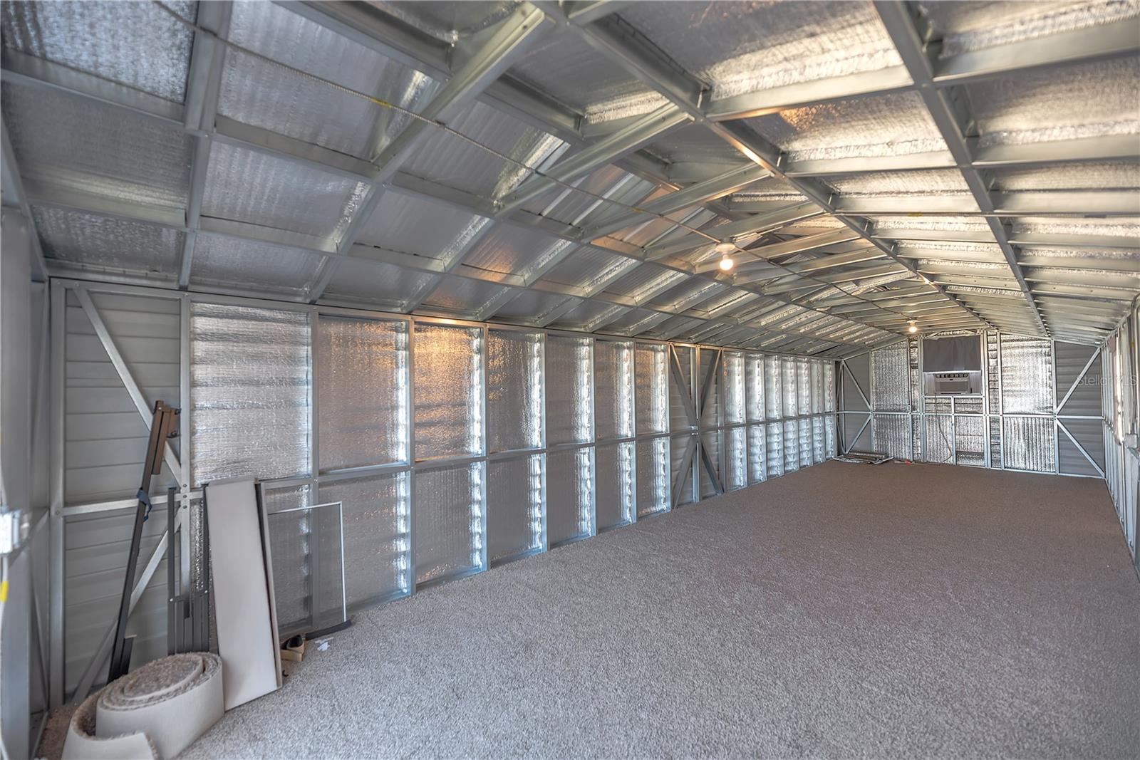Inside the 12' x 36' storage shed is carpeted and has insulation panels installed.