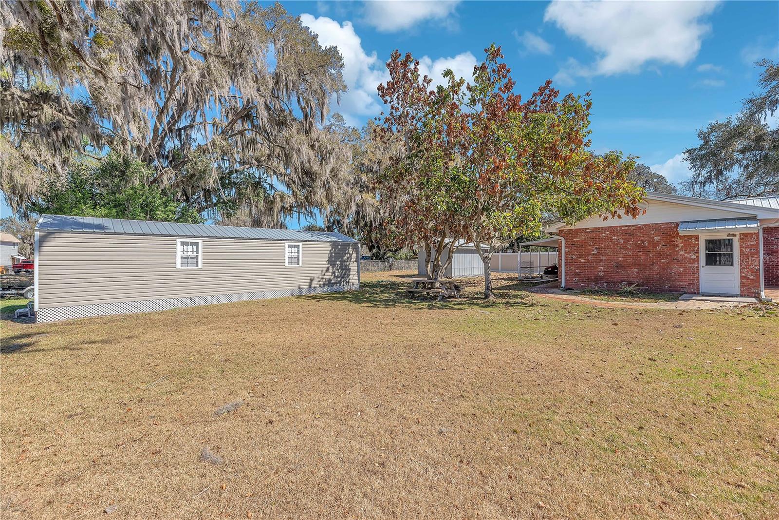 The two storage sheds are thoughtfully positioned to preserve unobstructed lake views from the home’s main living areas.
