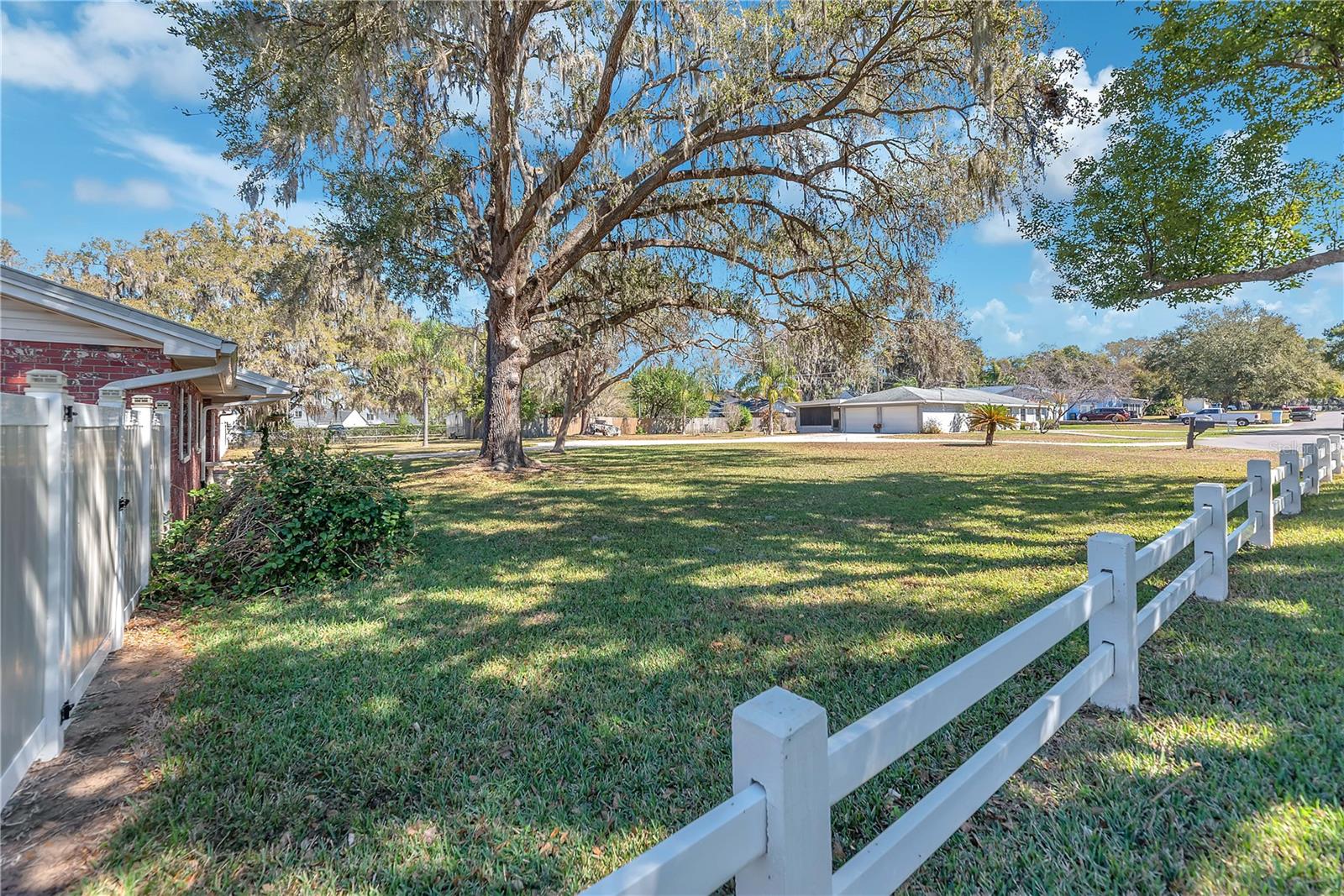Vinyl split rail fence is owned by the neighbor.