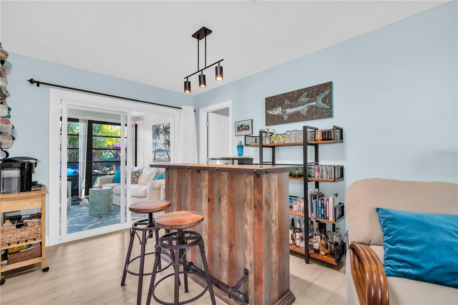 The dining area is currently serving as refreshment and coffee central location - with a convenient newer sliding door opening to the sunroom and patio areas ~