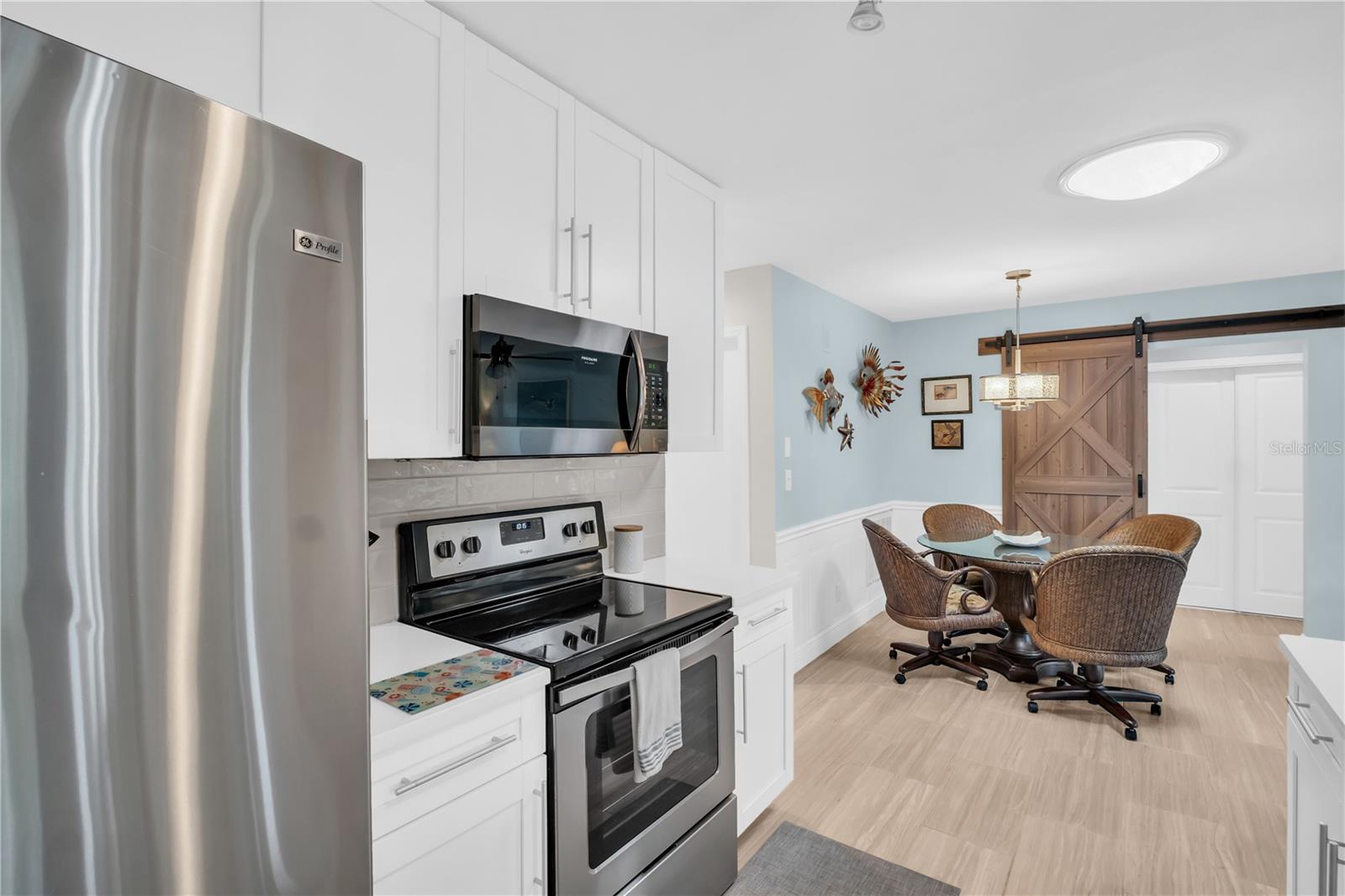 The modern barn door separating the 2nd bedroom and bath from the family room - gives guests their own private retreat ~