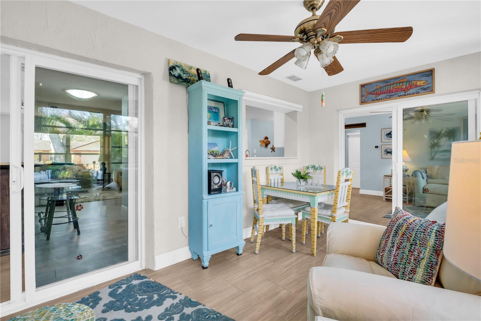 Sliding doors into the sunroom with the open pass thru from the kitchen pulls the living areas all together ~