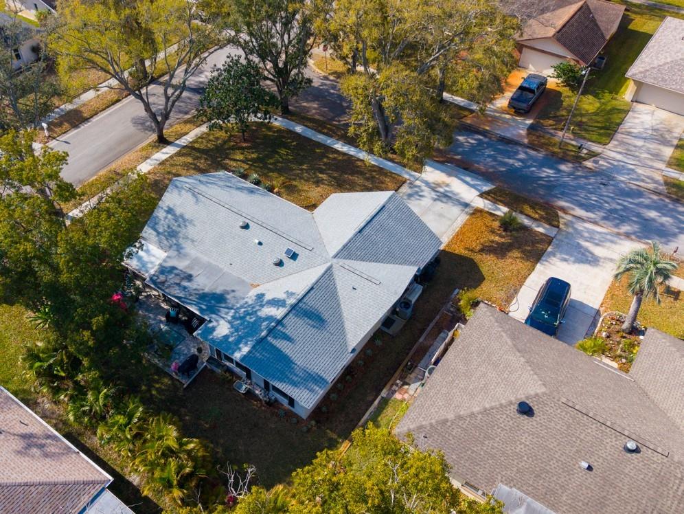 Aerial view of the large corner lot with privacy landscaping around the patio and back property areas ~