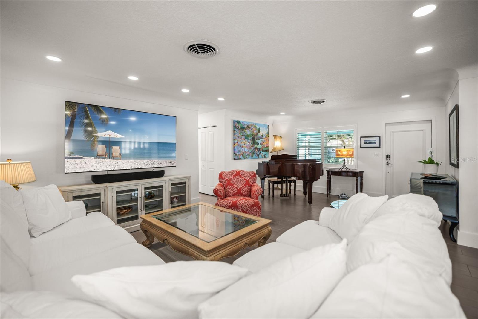 Living Room view of entryway  with piano in the corner