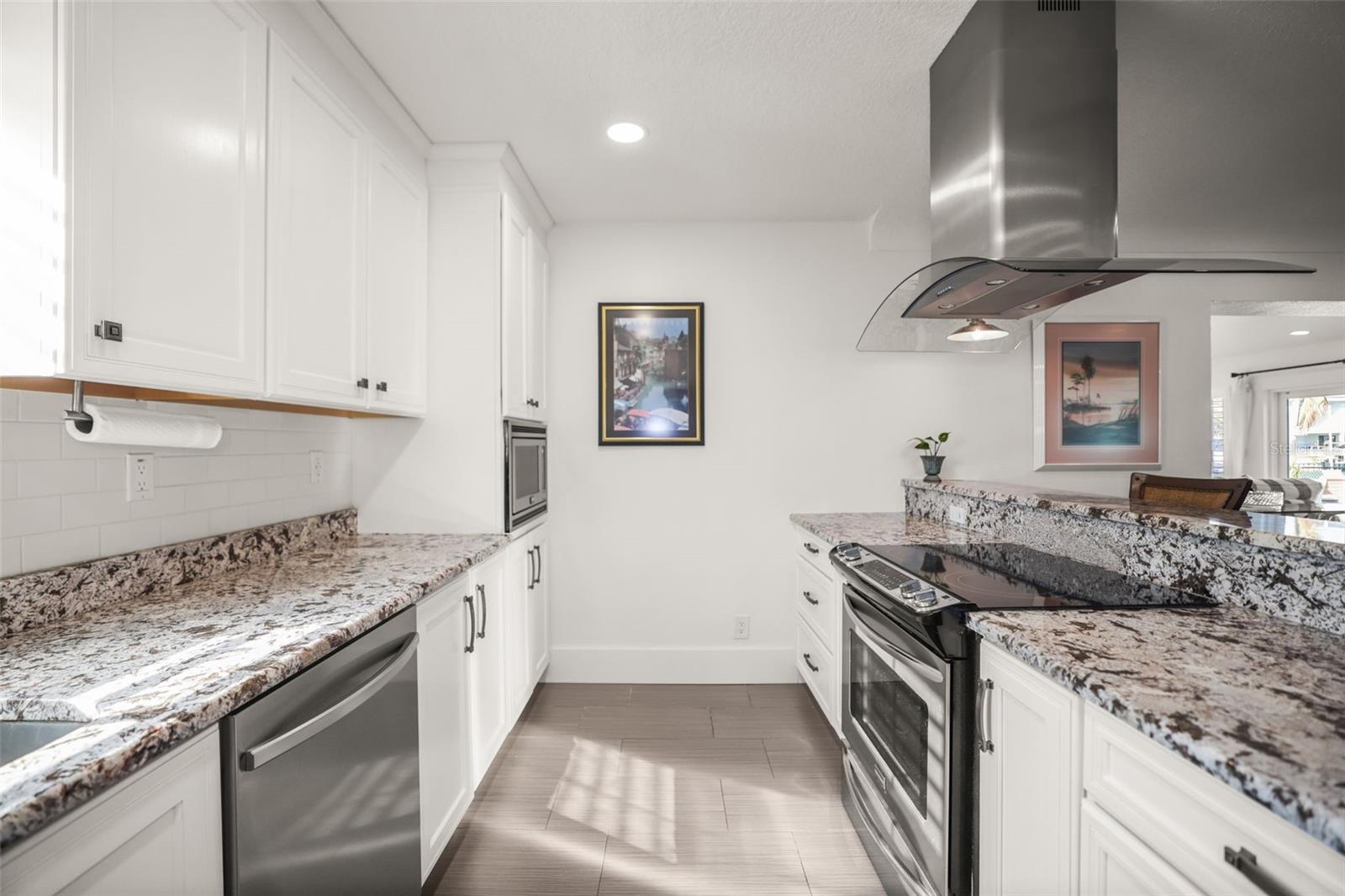 Galley Kitchen features Stainless Steel Appliances, Granite Counters
