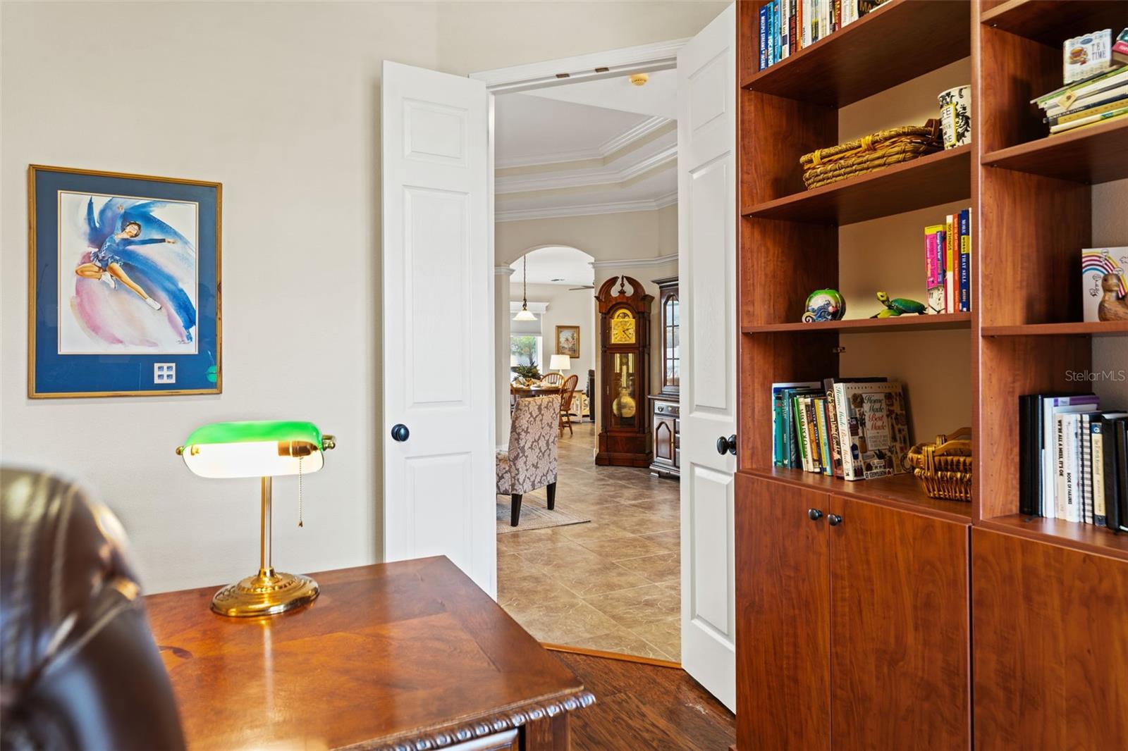 Custom built-in cabinetry and shelving add warmth and functionality, offering ample storage for books, décor, or workspace essentials.