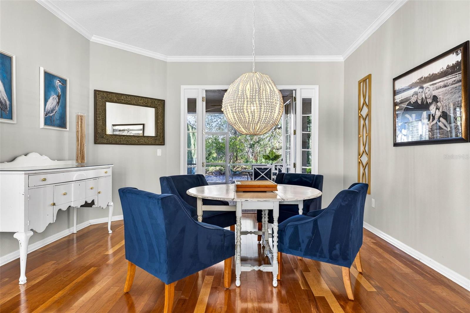 Hardwood flooring, crown molding and french doors make this area unique.