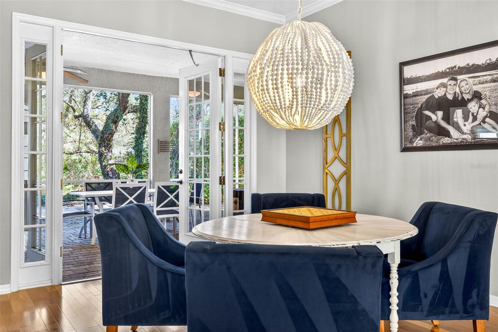 French doors open on to screened lanai with a view of the maturely landscaped backyard oasis.