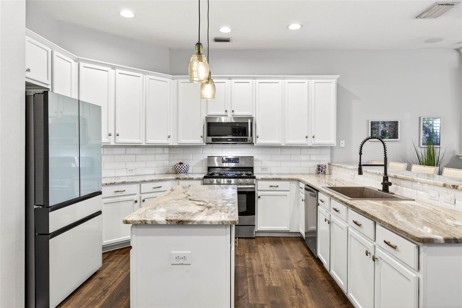 Well appointed kitchen with 42" cabinets complete with hardware, granite countertops and stainless steel appliances.