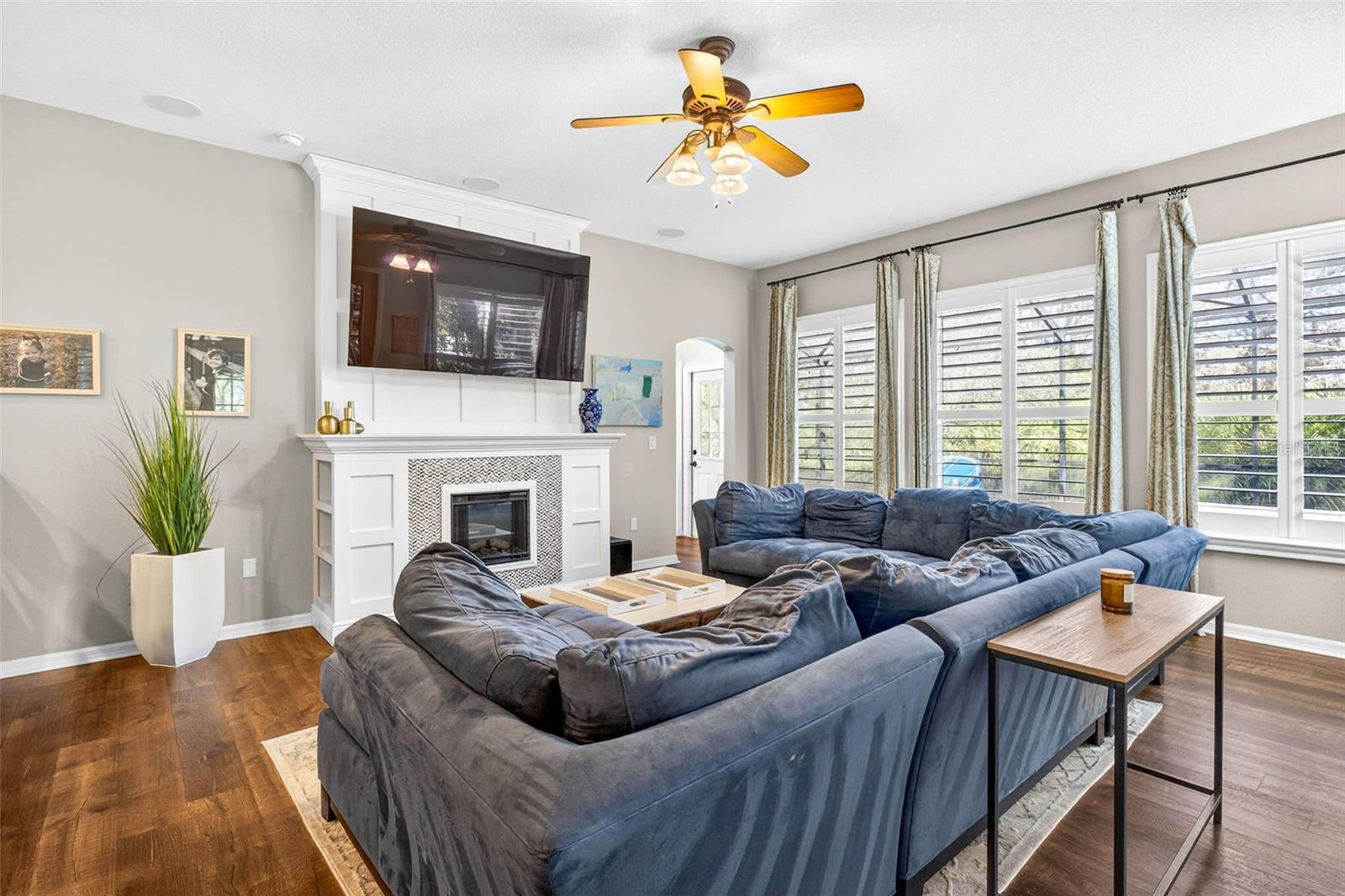 Large family room anchored by a bay of windows along that back which brings in views of the naturally landsccaped backyard oasis.