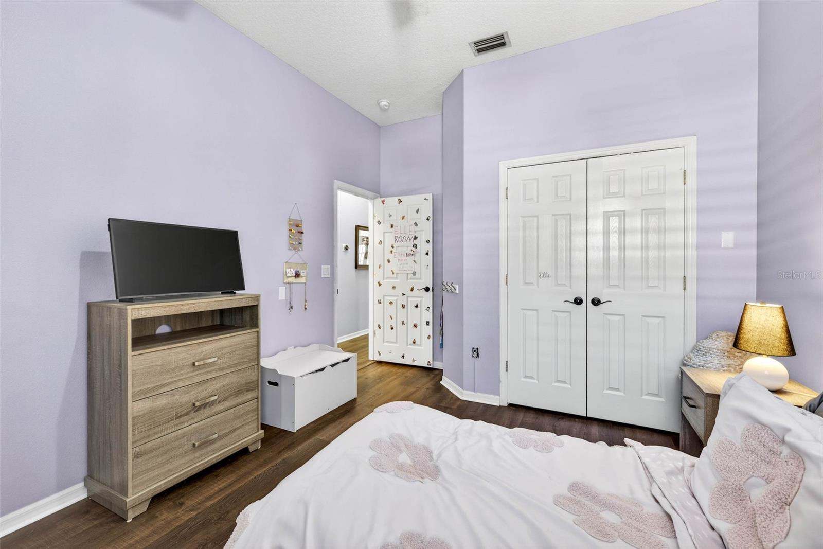 Secondary bedroom with french doors to built in closet
