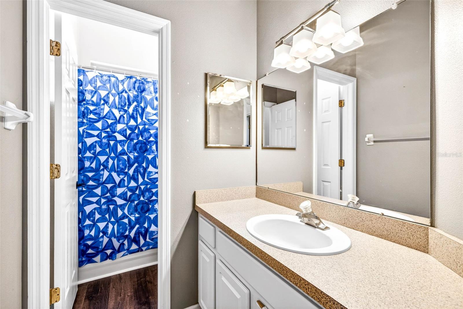 Secondary bathroom shared between the two bedrooms. Separate vanity from wash closet and tub/shower combination.