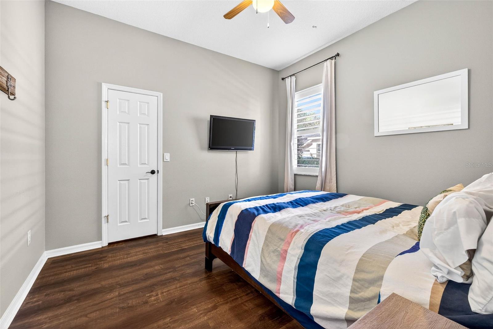 Fourth bedroom located towards back of the house with ceiling fan and walk in closet