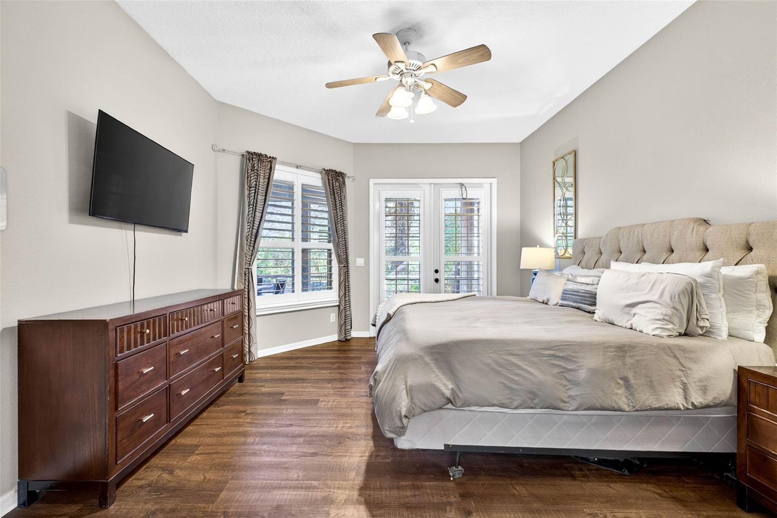 Primary bedroom complete with ceiing fan and plantation shutters.