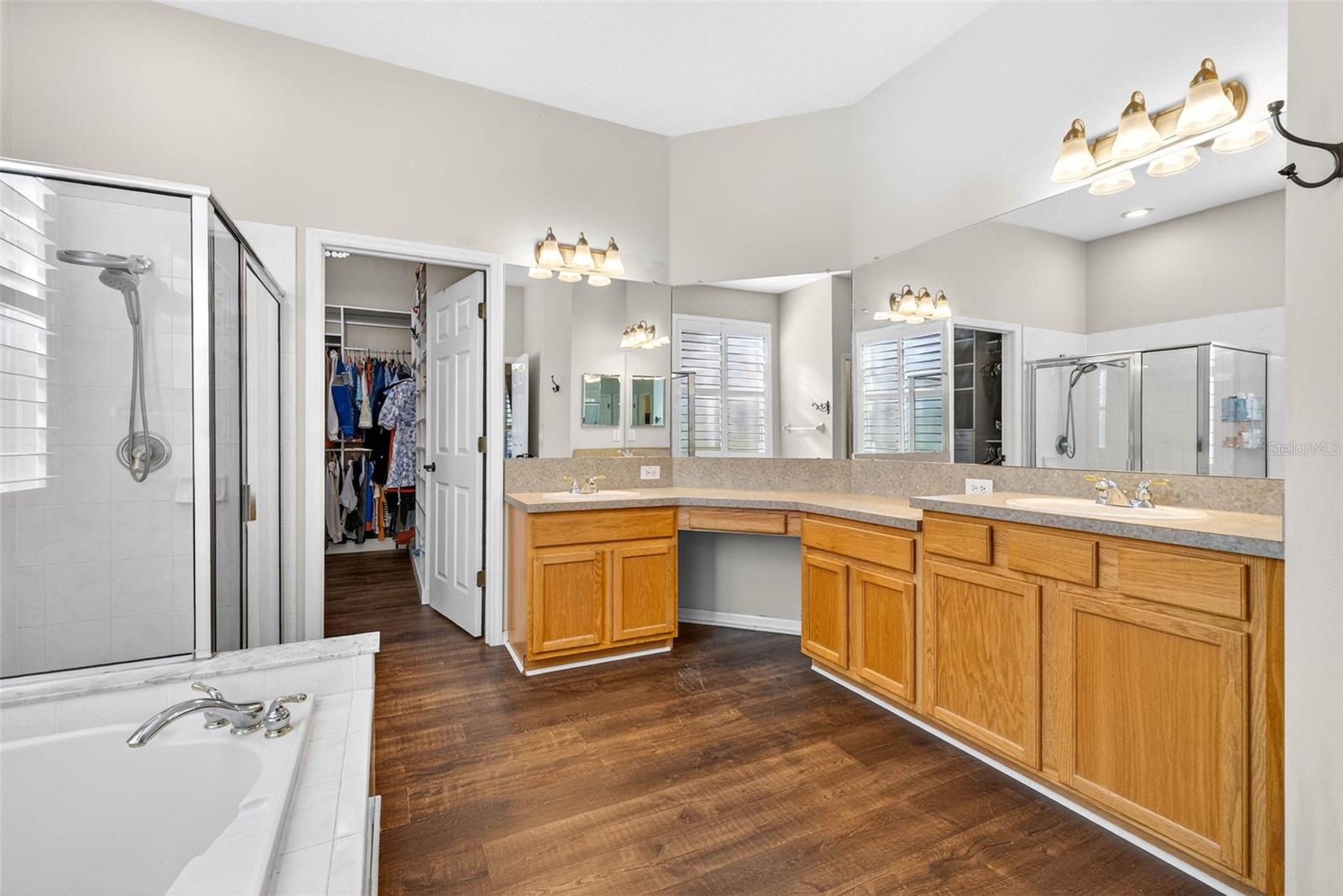 Vanity has dual sinks and an area for seating.