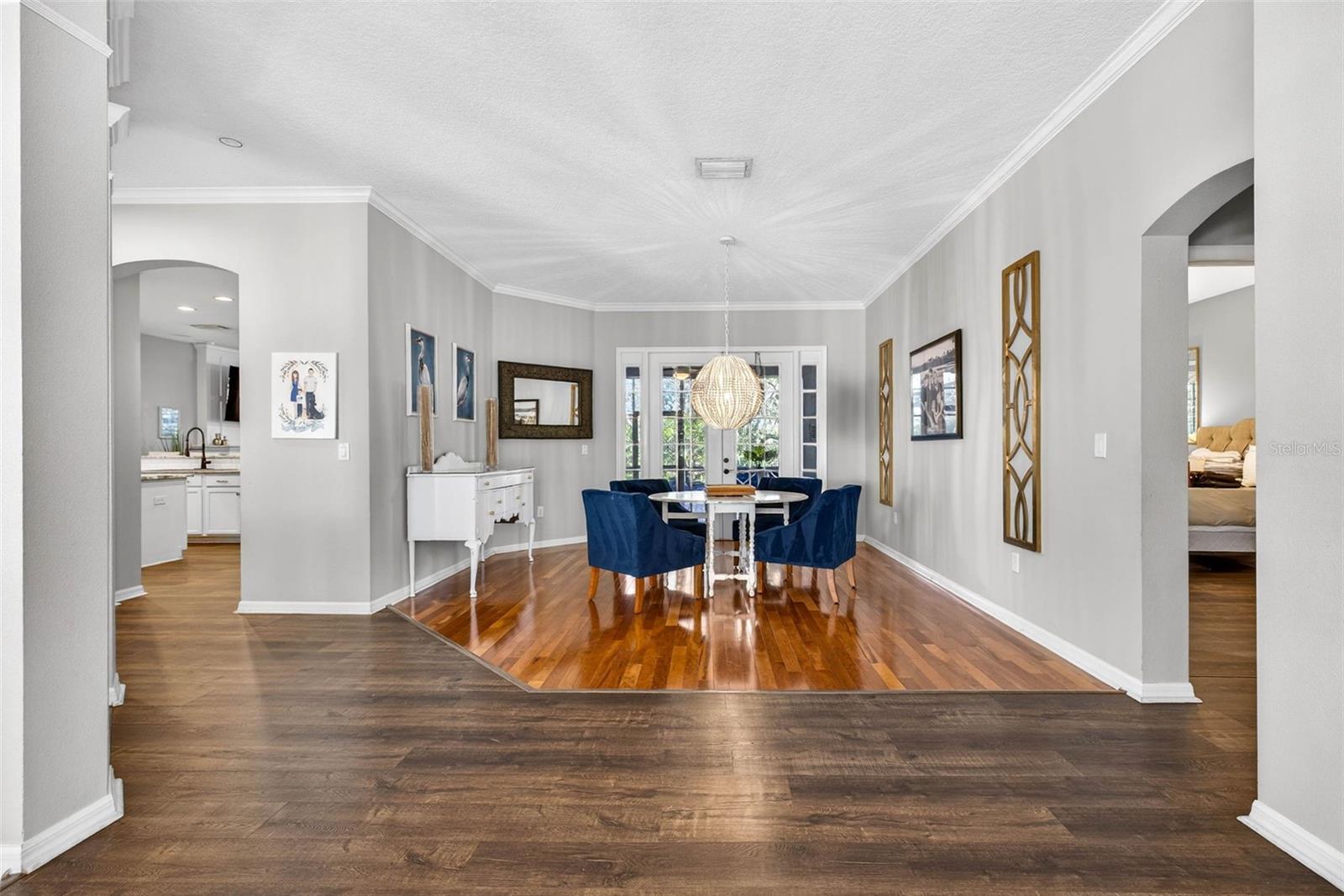 Grand entry to foyer with views straight through the french doors to the maturely landscaped backyard oasis.