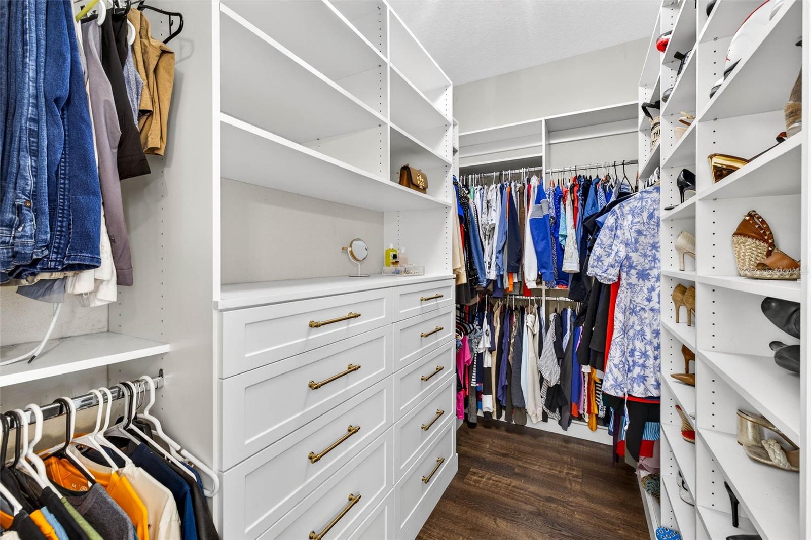 Primary closet conveniently built out to maximize storage space