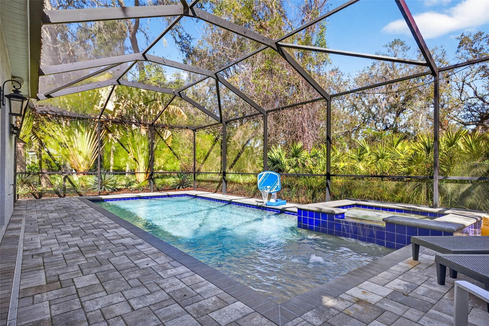 Screened in salt water pool with sunning deck and spa. Gas heated.