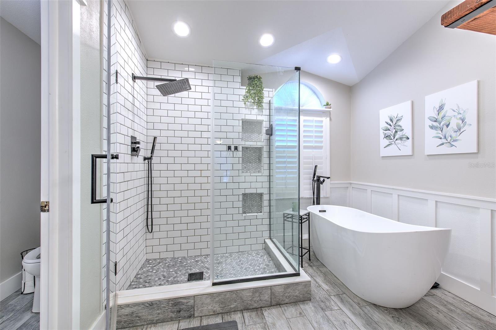 Glass Shower and Garden Tub with Water Closet in Primary Bathroom