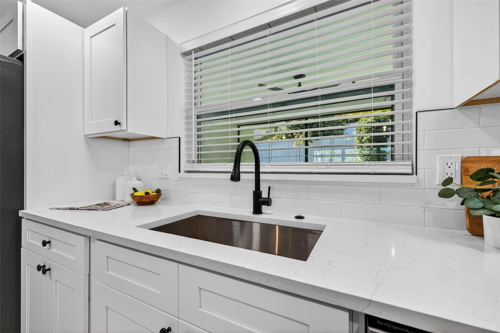 Overlooking the lush backyard, this kitchen combines function with style.