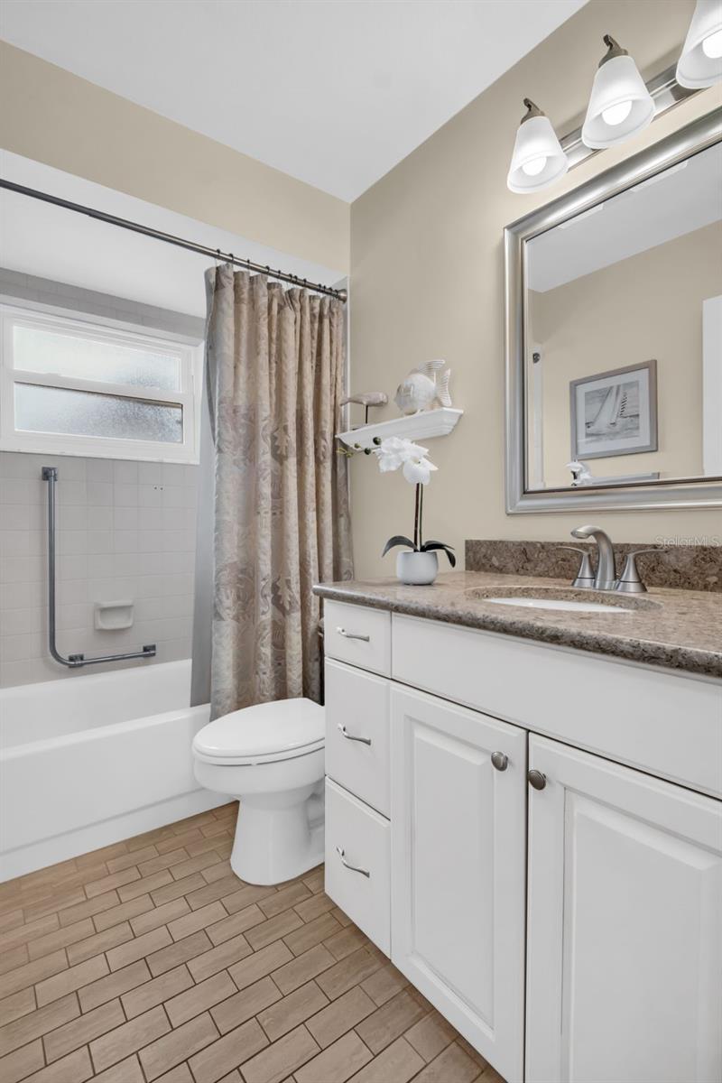 Beautifully updated hall bath with convenient tub/shower combo & updated vanity~