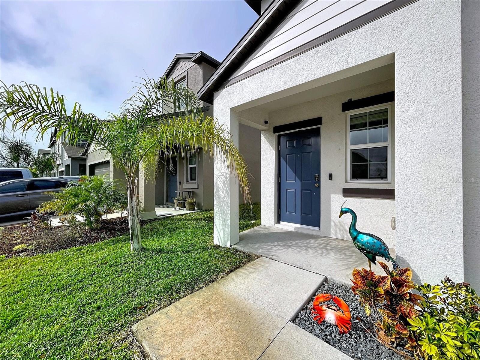 Front porch, home has hurricane shutters to cover the windows when needed!