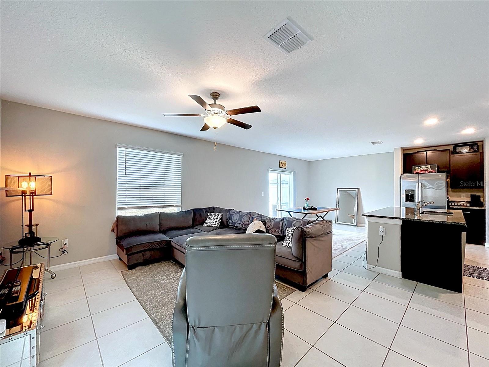 Living room, large ceramic tiles flooring through the dining room as well.