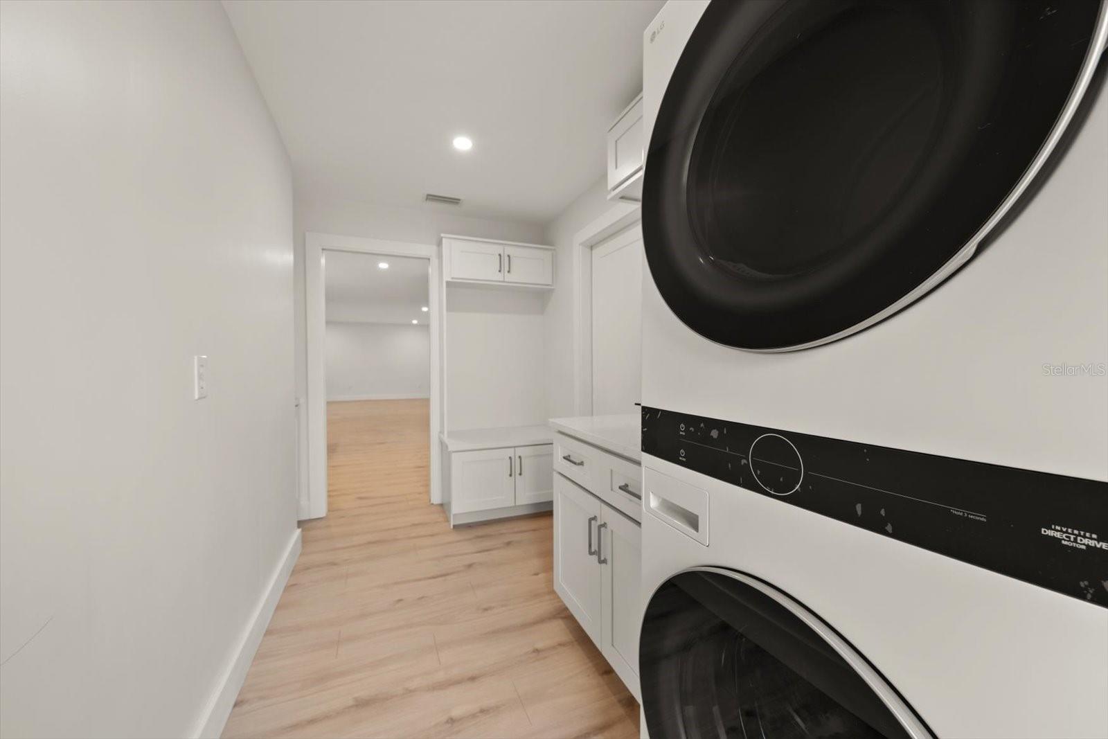 Inside Laundry room with stackable washer and dryer