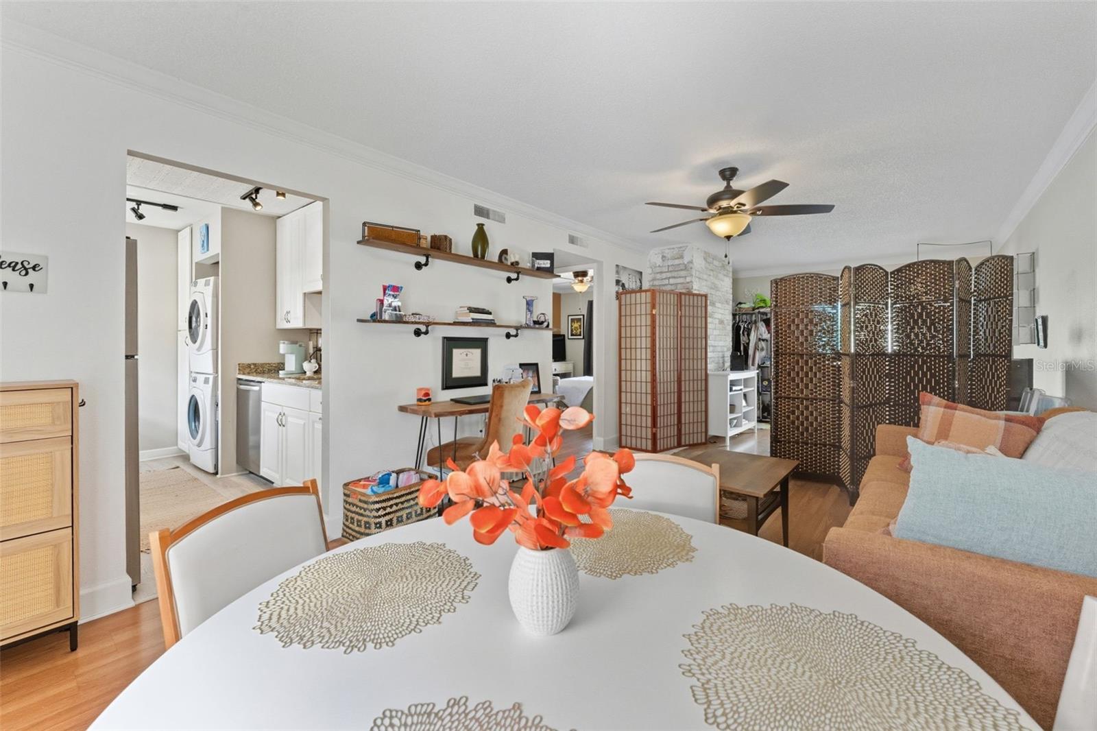 Bright and welcoming dining area filled with beautiful natural light, seamlessly flowing into the comfortable living room — perfect for everyday living