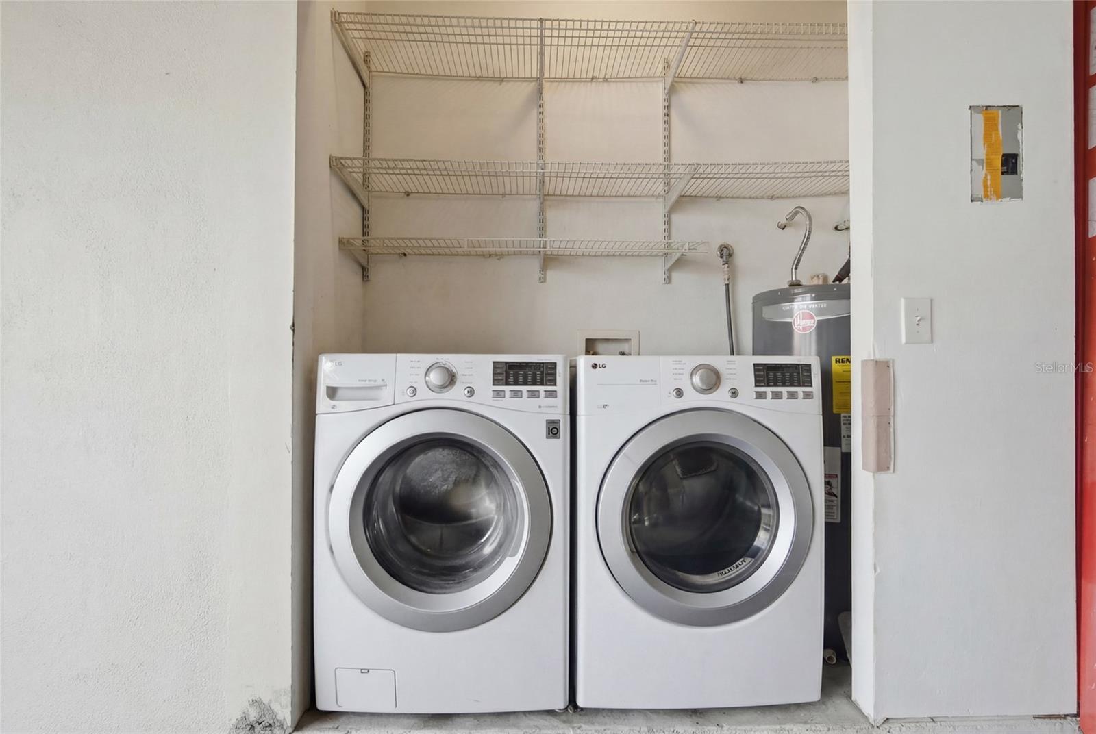 Full Size side by side Washer & Dryer in 2 car garage that conveys.