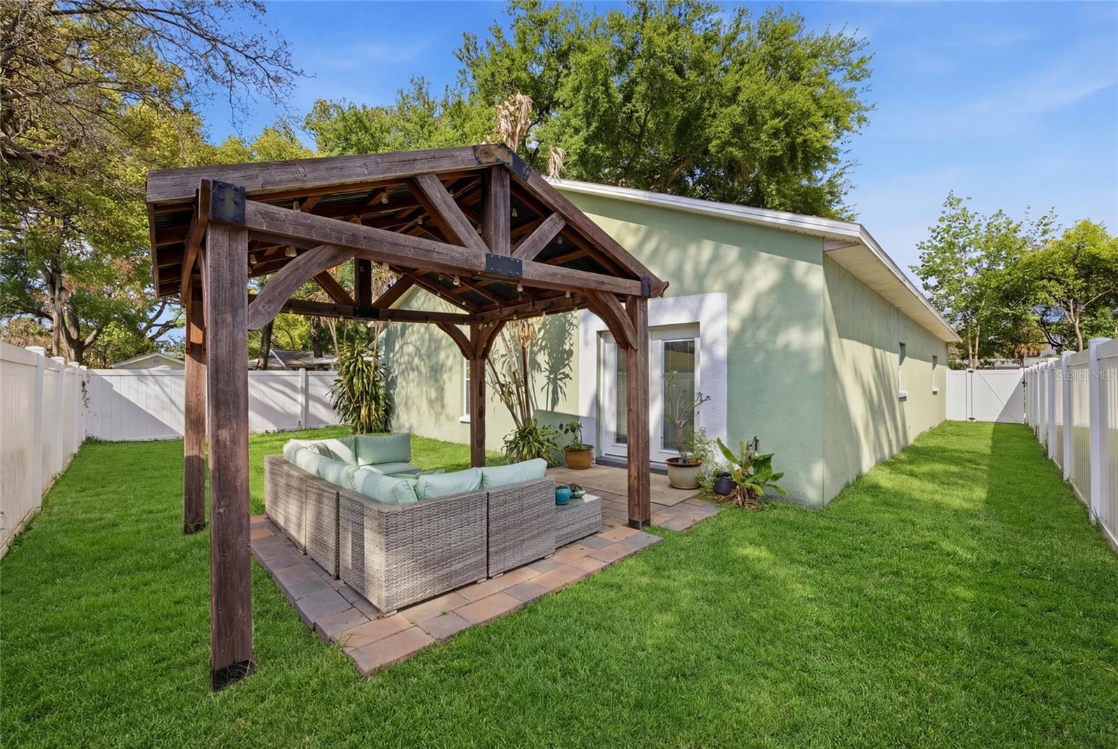 Pergola and pavers. Outdoor furniture conveys.